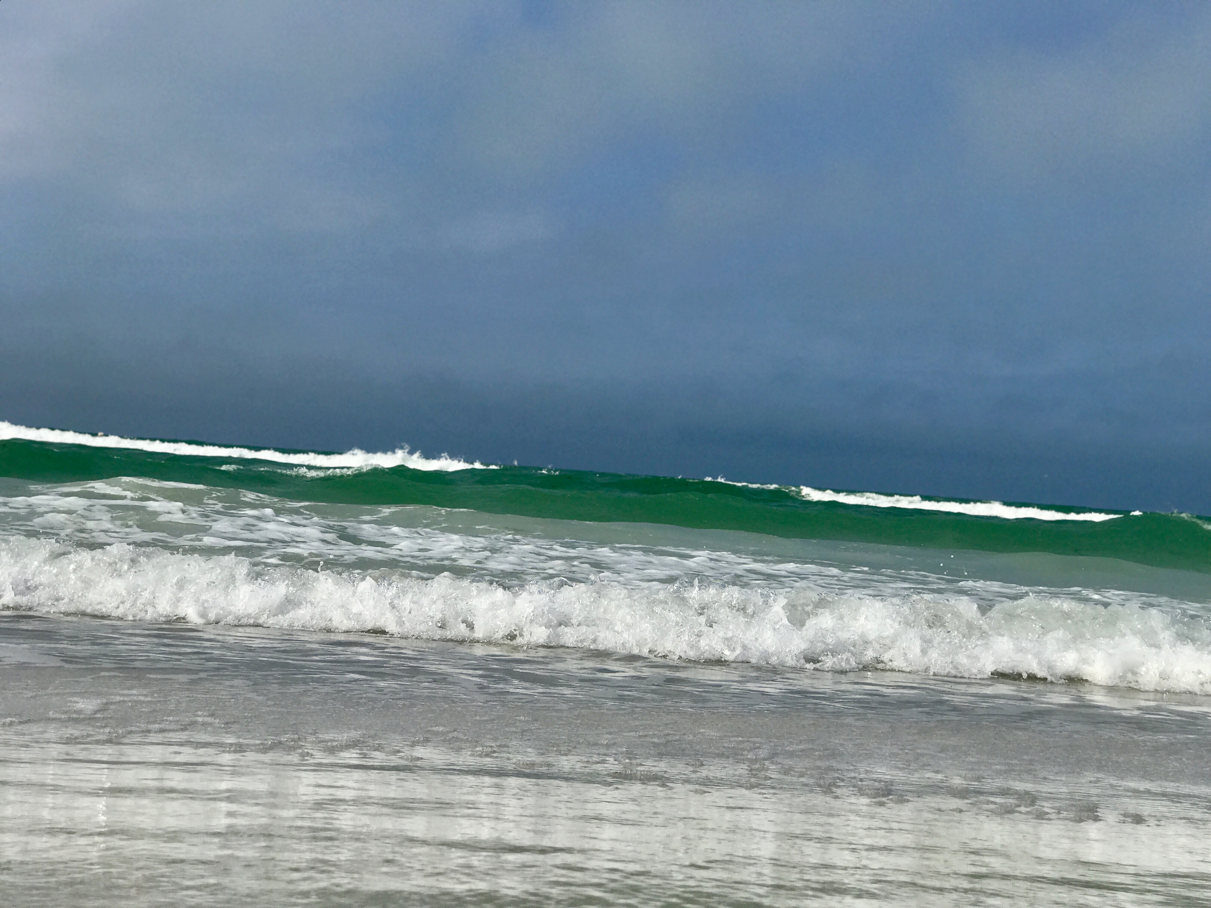 Beach waves on a cloudy sky